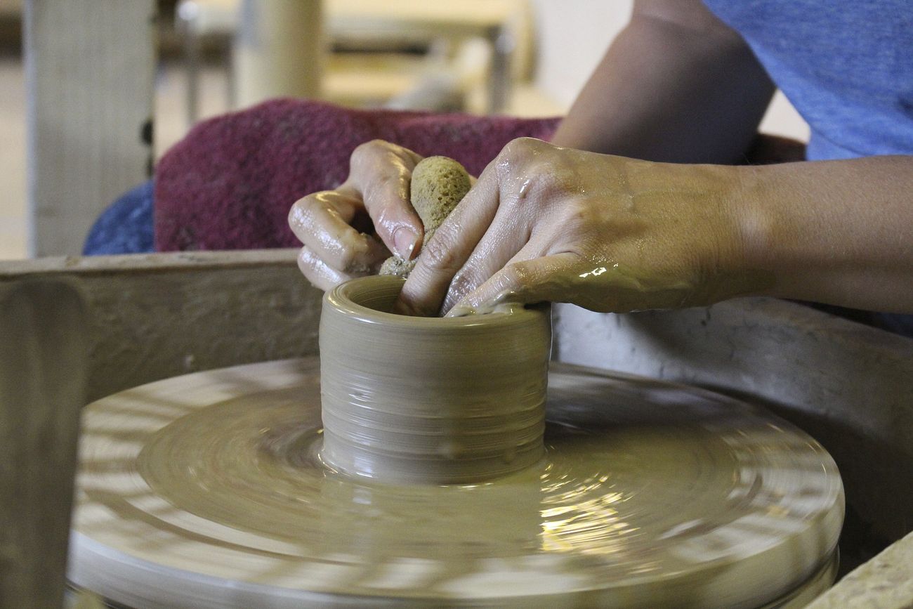 Free person making handmade pottery