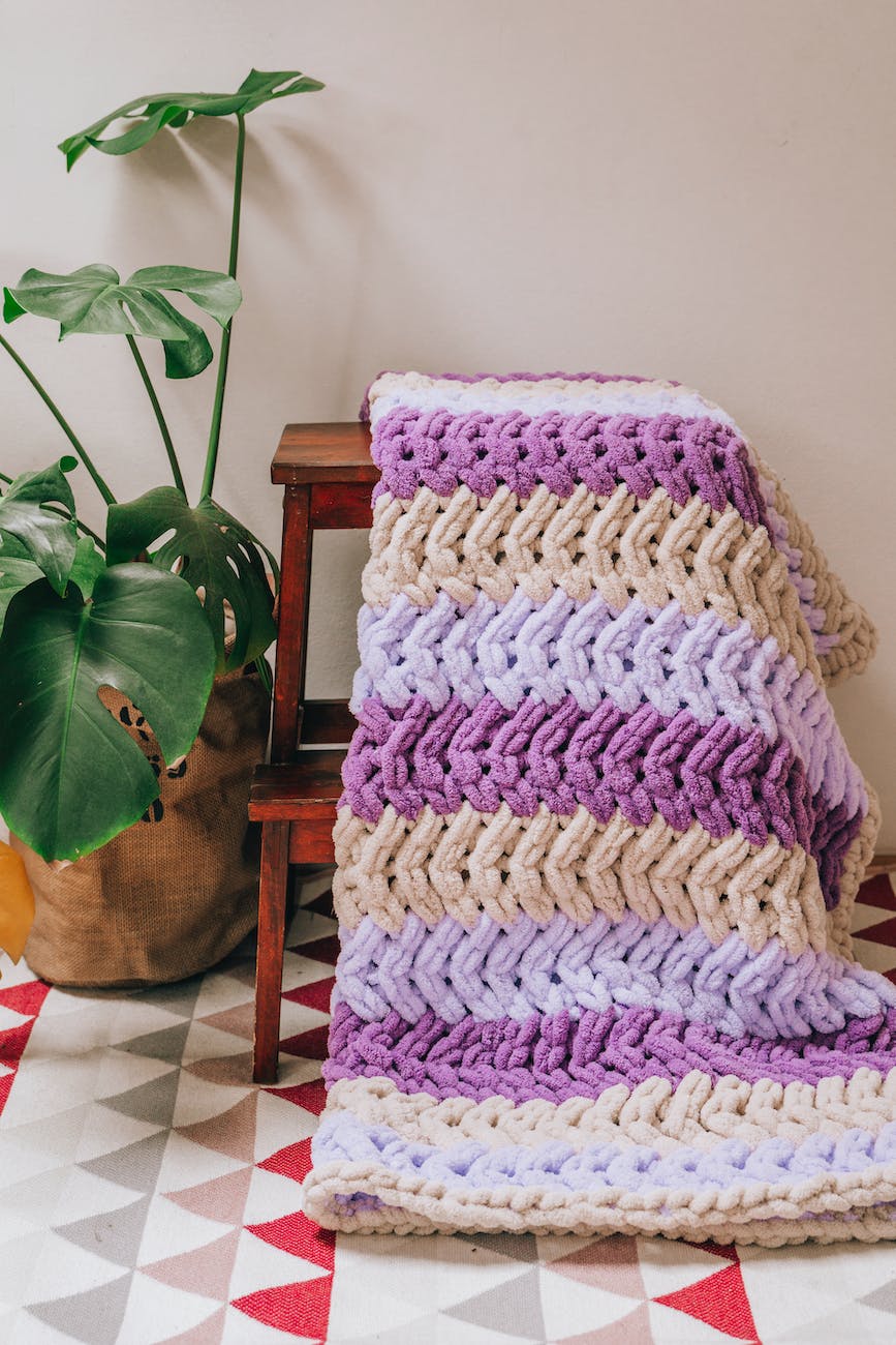 crocheted blanket draped over stool