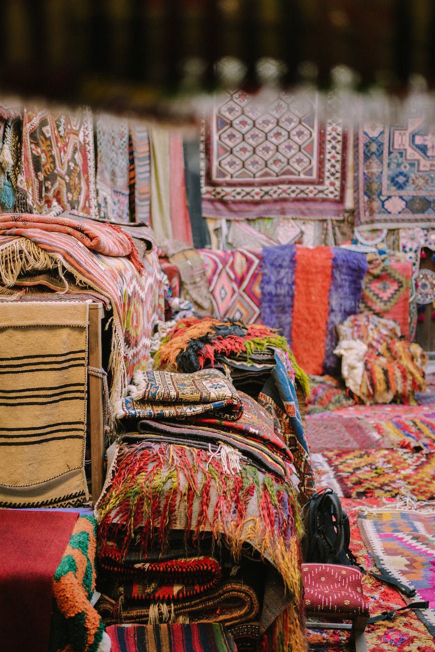 variety of handmade moroccan blankets displayed on a store
