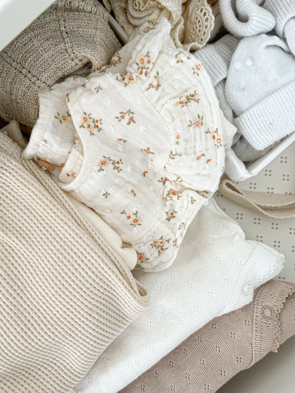 close up of baby clothes in neutral colors