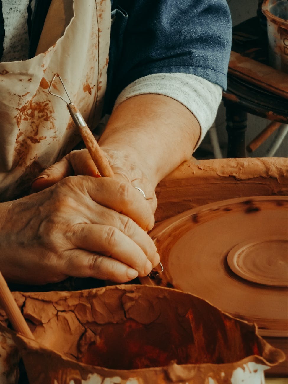 hands of a woman sculpting from clay