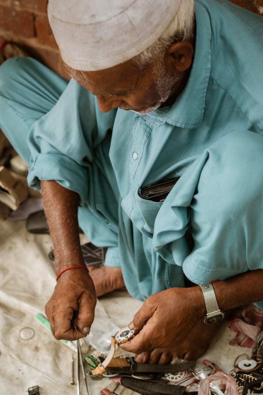 man repairing wristwatch