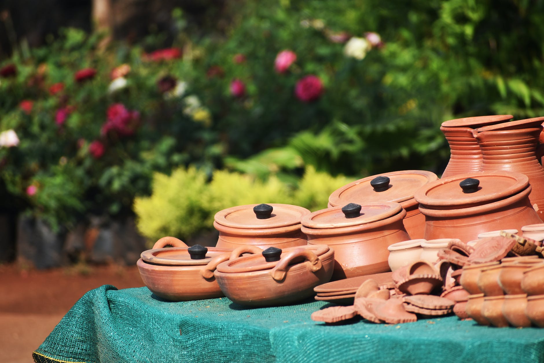 table full of clay pots bowls and plates