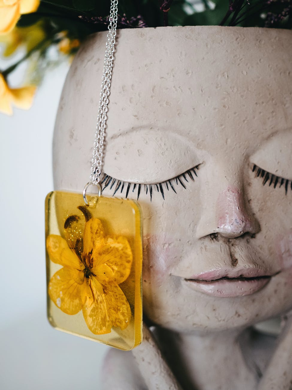 yellow flower encased in resin necklace