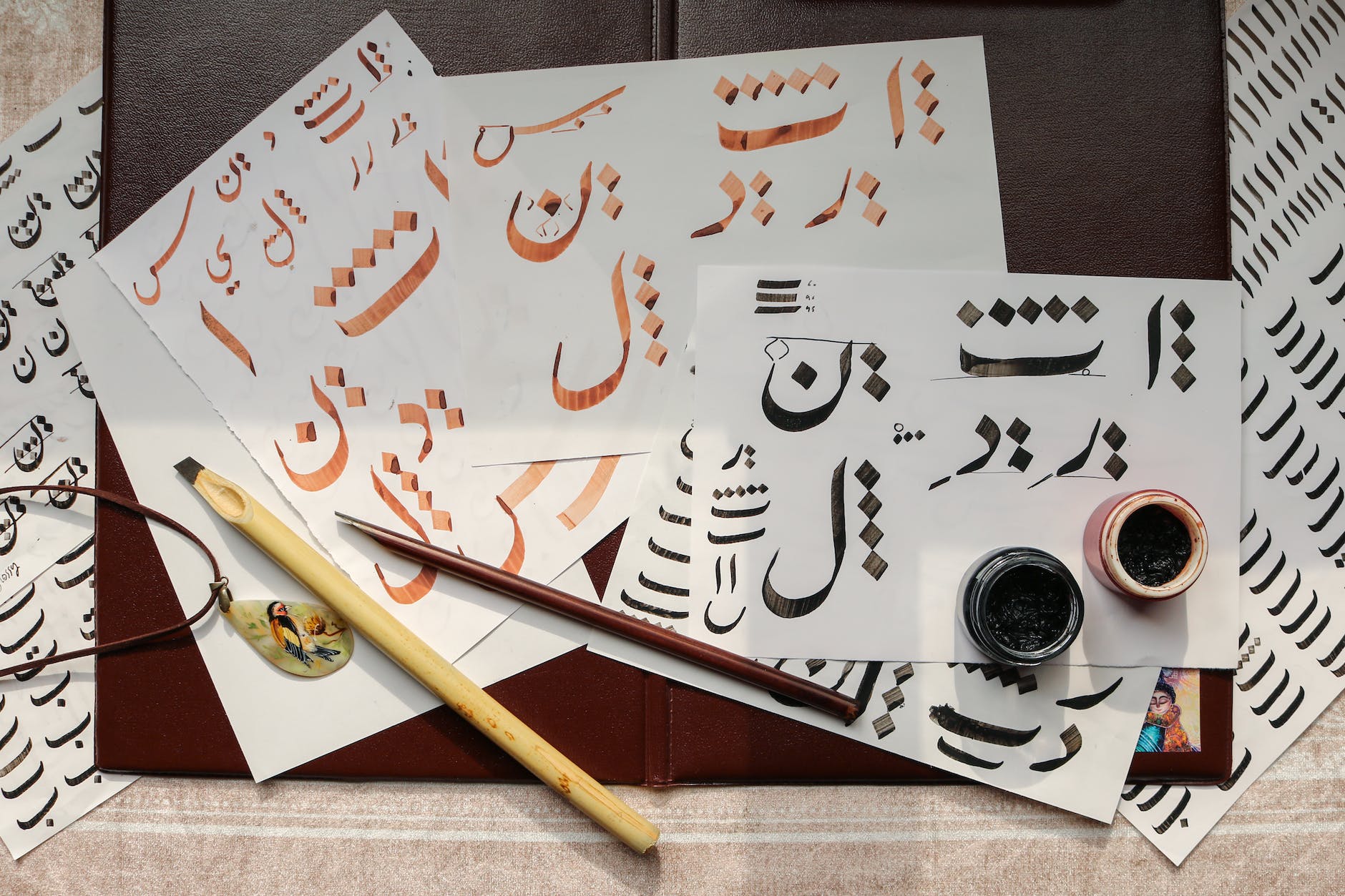 white papers on table with written calligraphy art