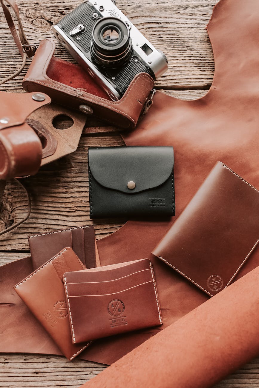 leather wallets on wooden table