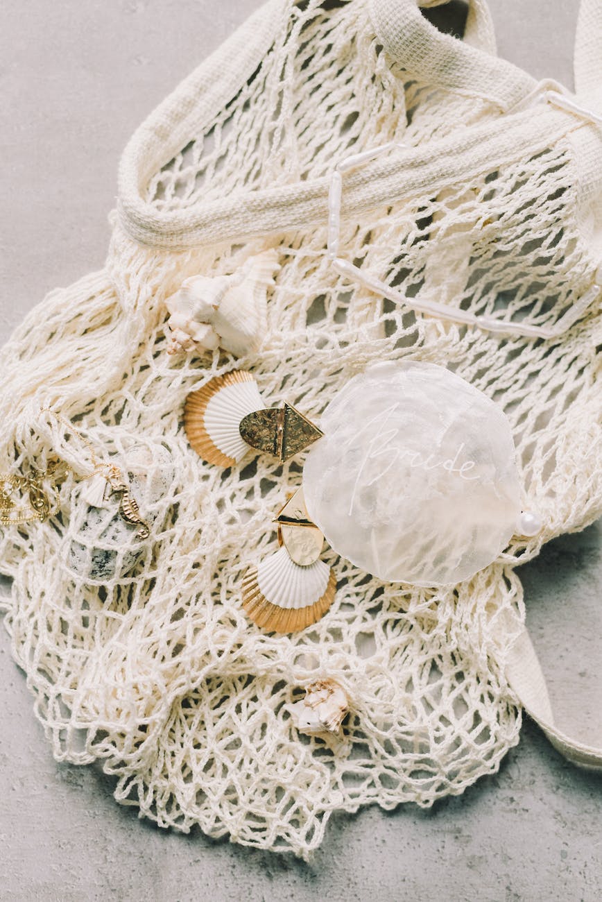 white rope bag with seashells