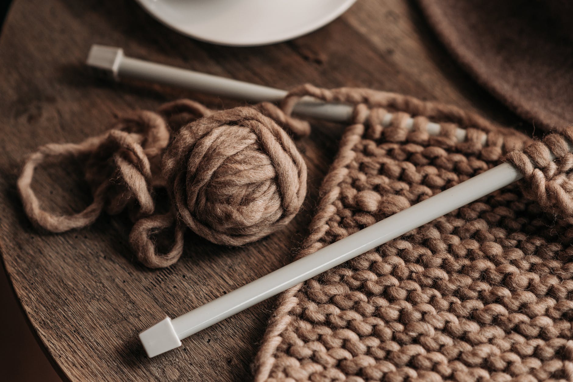 knitting needles on a brown yarn