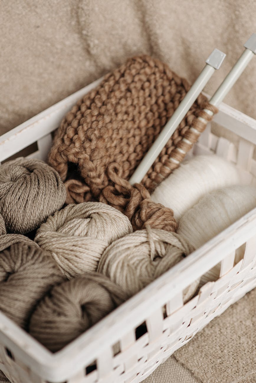 white and brown yarns in basket