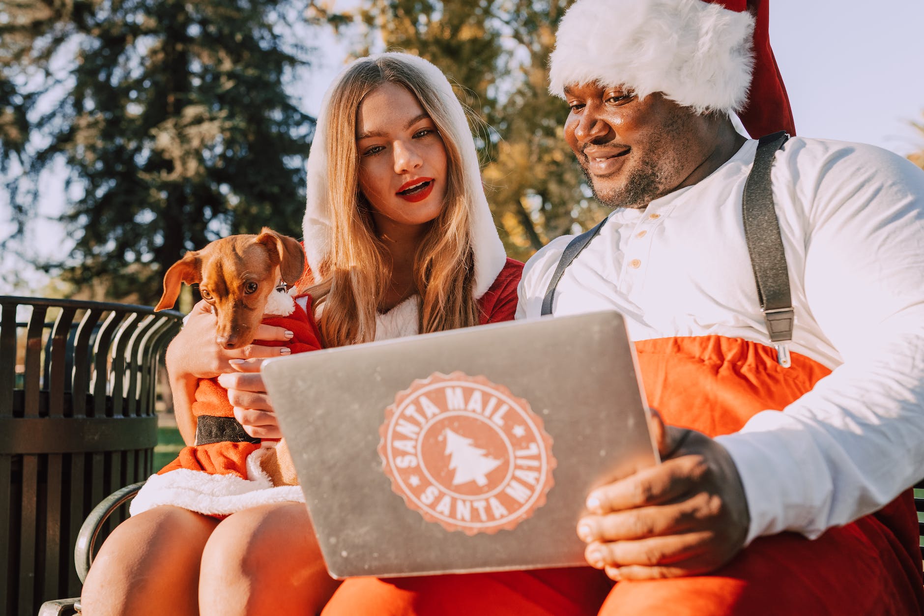 a man and woman in santa costumes sitting while having conversation