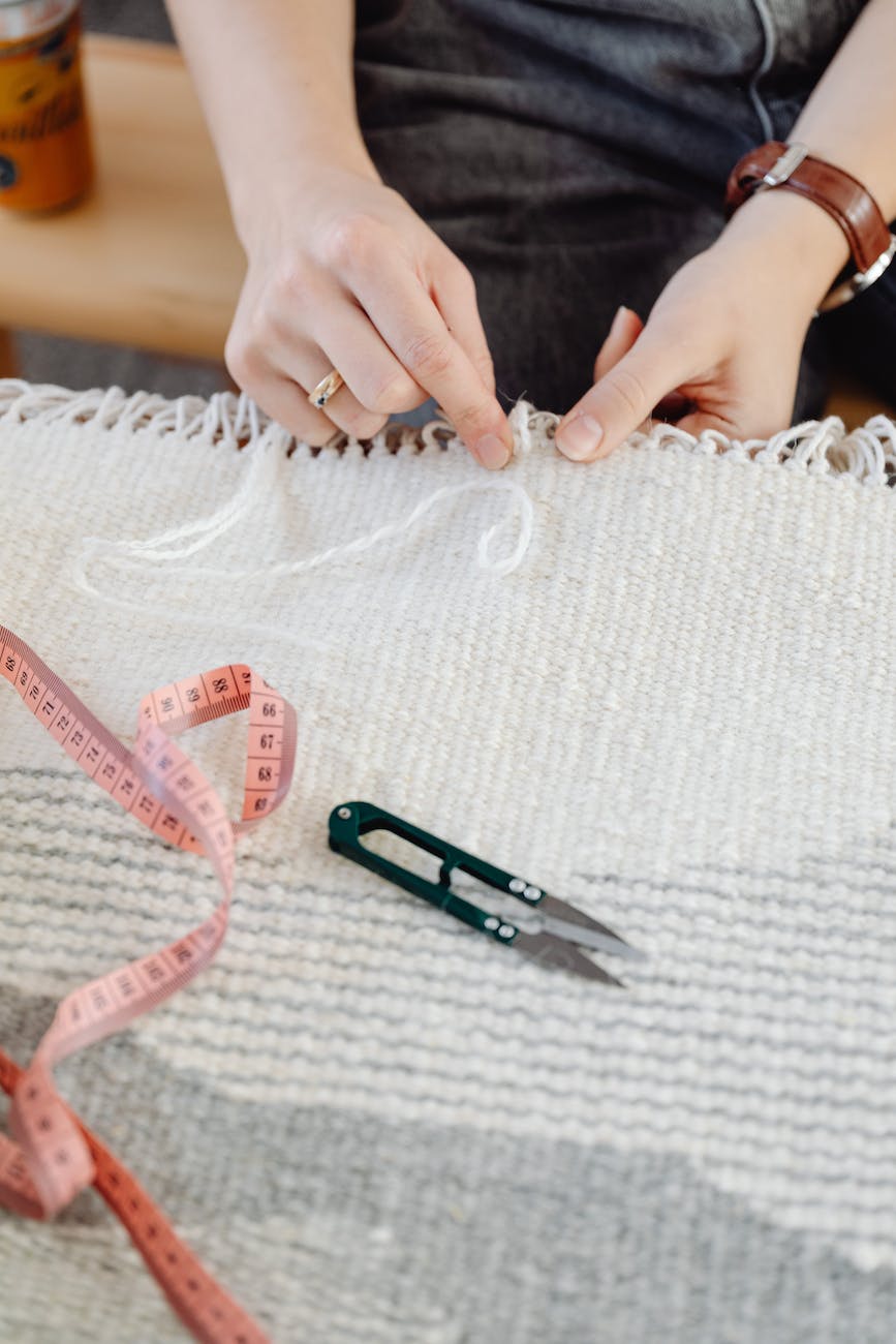 woman weaving wool rug