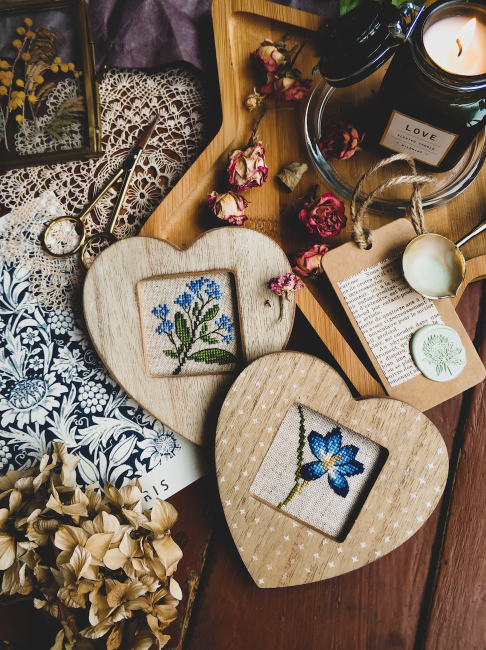 frames with embroidered flowers on table