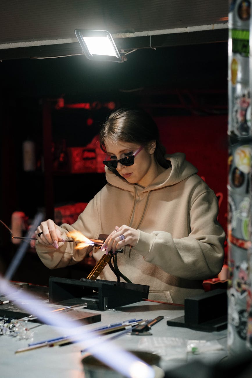 a woman in hoodie jacket and sunglasses while working