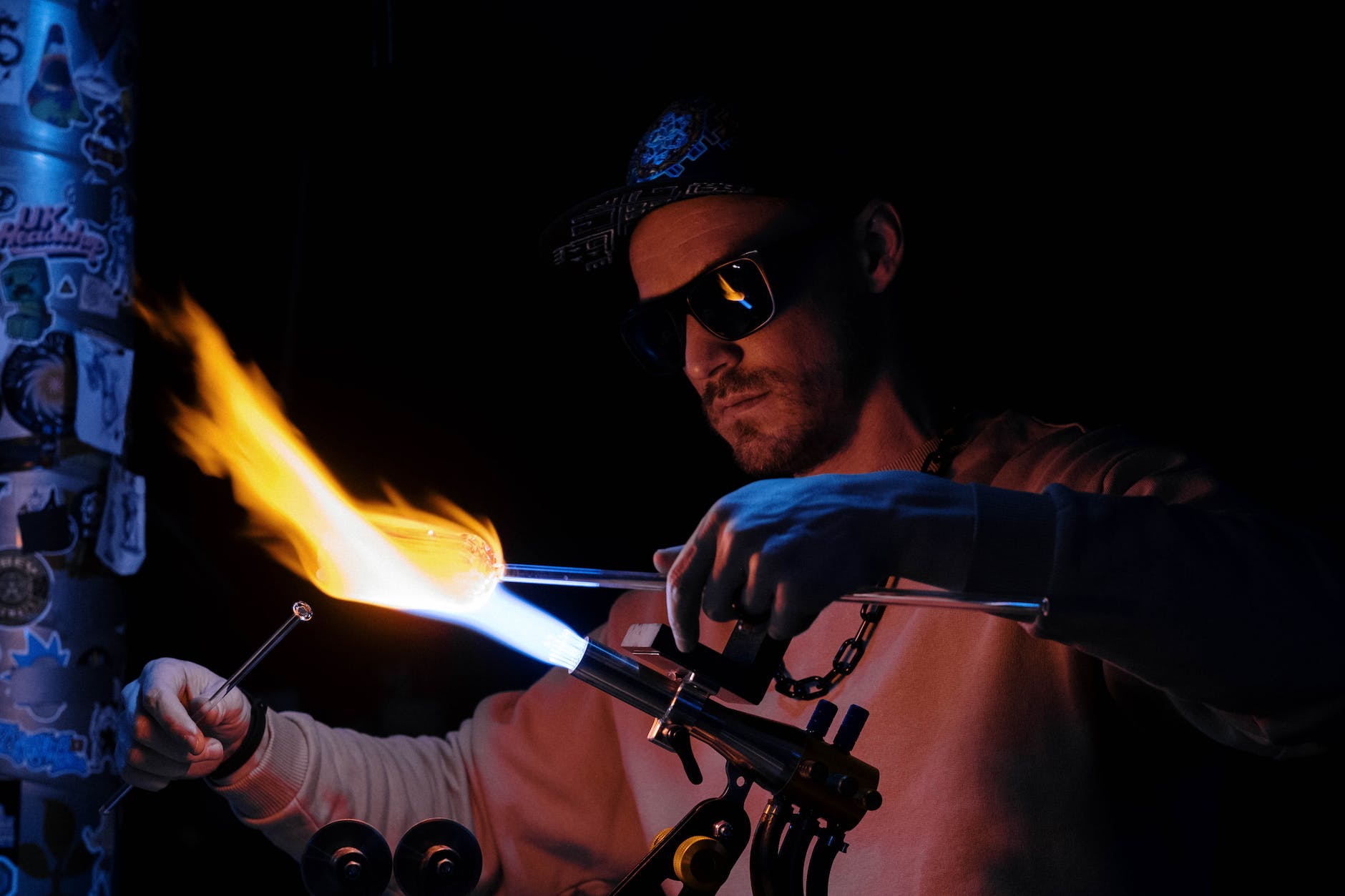 man in black sunglasses holding fire