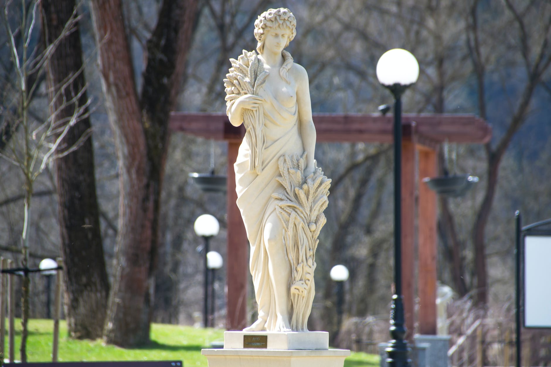 woman statue beside street light
