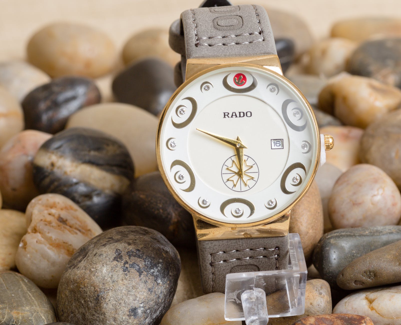 rado wristwatch with gray leather strap